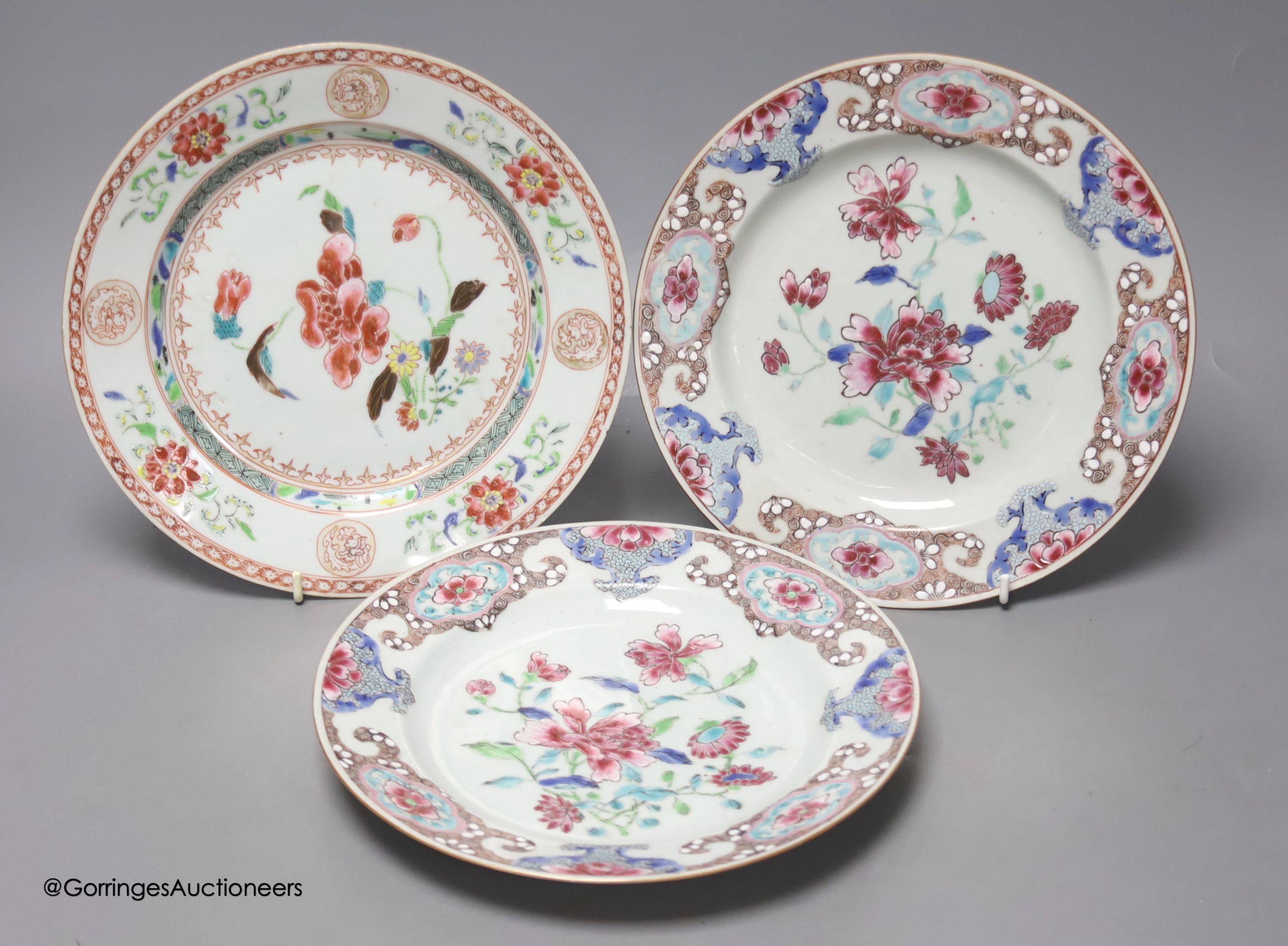 A pair of 18th century Chinese famille rose plates and another similar, largest diameter 22.5cm (damage)